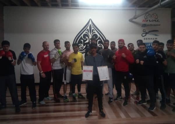 Rizwan Aslam is congratulated by his teammates at the Purge Boxing Academy in Batley following his victory in the England Development Championships last Saturday.