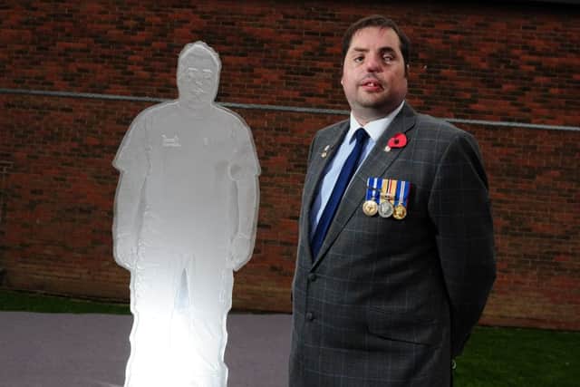 War Veteran Simon Brown pictured with the statue at Woodkirk Academy, Tingley