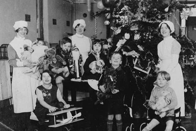 RAISING CHRISTMAS SPIRITS: Christmas past at Staincliffe Hospital as the nurses make sure the childrens ward have a lovely Christmas tree and that their young patients have plenty of presents.