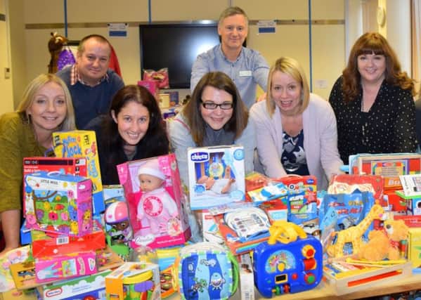 CHRISTMAS CHEER: The KNH staff with some of the donations.