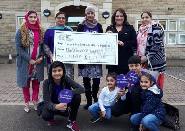 STROLL STARS: Cllr Mussarat Pervaiz, Paula Sherriff MP, and family and friends with the cheque.