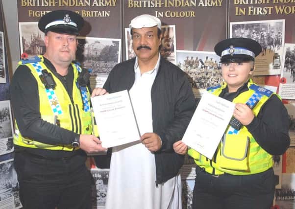 AWARDS: Zamir Ahmed, centre, presents certificates to PCSO Stephen Reynolds and PCSO Laura Esteves.