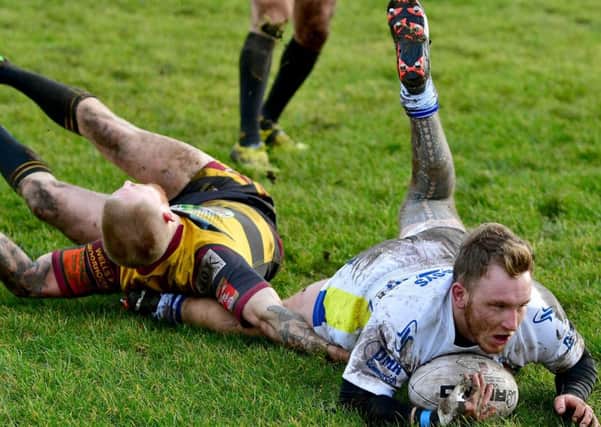 Josh Knowles dives over for a try during Saturday's Challenge Cup clash at Underbank Rangers.