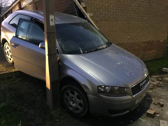 The abandoned car crashed into garages in Cleckheaton.