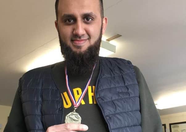 Ismail with his Dewsbury 10k race medal