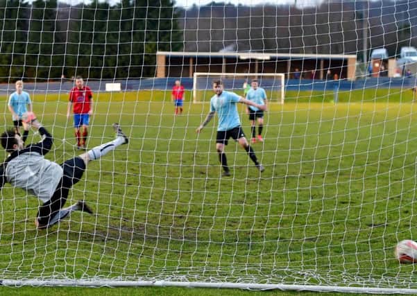 Brandon Kane slots home the winning penalty to send Liversedge into the next round of the NCE League Cup.