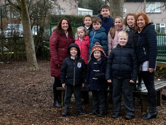 Staff and pupils of St Patricks Catholic Primary School on the patch of land earmarked for a new quiet play area.