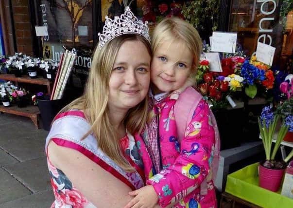 Beauty pageant winner Clare Hurst poses for the picture with her young fan