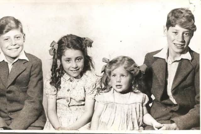 FAMILY GROUP: The photograph above shows George and his siblings, Pat, Rosemary and Wilfred, after the war ended. They are wearing their first Whitsuntide clothes for some time because during the war clothing was rationed.