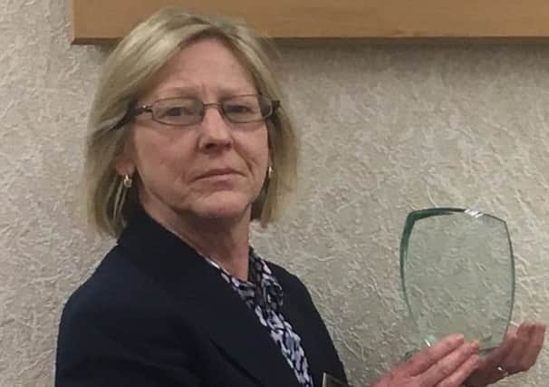 BRANCH MANAGER: Diane Stuckley with her plaque.