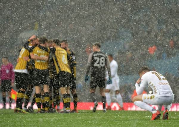 Disappointed Stuart Dallas looks on in the snow at full-time as Sheffield Wednesday celebrate their 2-1 win at Leeds United.  Picture: Bruce Rollinson