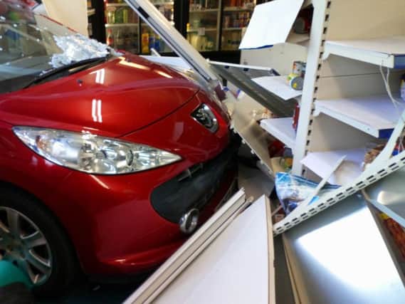 The car lost control and smashed into the White Lee Off-Licence on Monday afternoon.