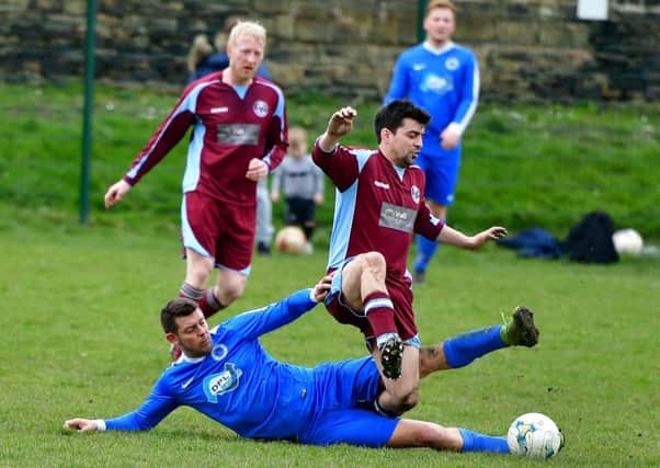 Crackenedge player James Goodall challenges a Honley rival during his side's West Riding County Challenge Trophy quarter-final.