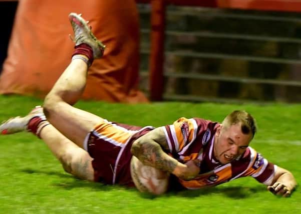 Jason Crookes dives over for a 60th minute try which helped Batley clinch victory. Pictures: Paul Butterfield
