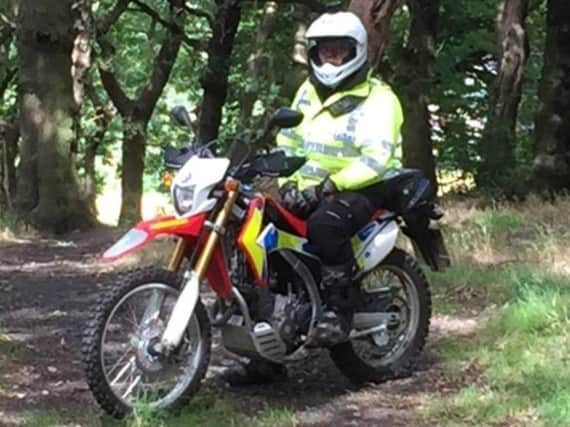 a police officer on an off-road bike