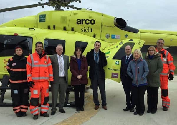 Yorkshire Air Ambulance Pilot Elaine Hunter and Paramedic Darren James with B&M area manager James McCluskey, staff from the B&M Wakefield store and YAA Doctor Tim
Moll.