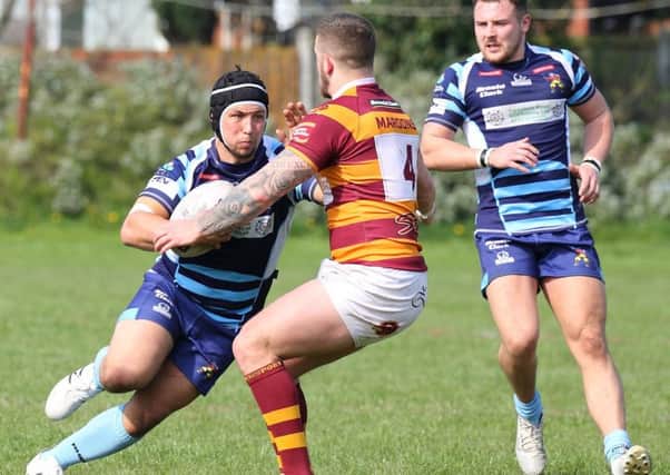 A Dewsbury Moor defender attempts to get to grips with Hunslet Warriors Daryl Gaunt during last Saturdays National Conference League Division Two clash. Picture: Craig Hawkhead