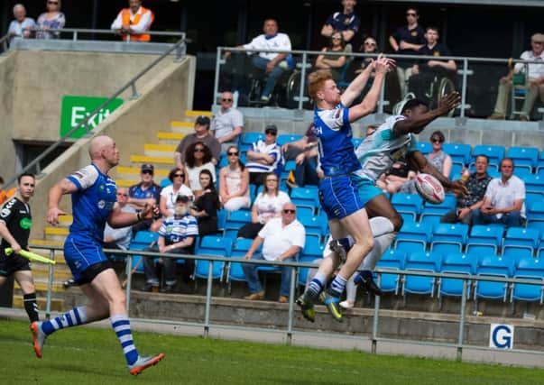 Halifax winger Conor McGrath challenges for the ball with Dewsburys Rob Worrincy during Sundays Championship clash at The Shay. Pictures: Bruce Fitzgerald