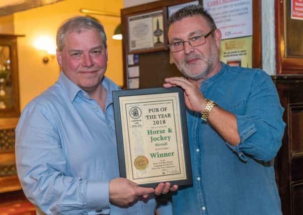WINNER: Andy Kassube (CAMRA) presents the pub of the year certificate to landlord Tony Anderson.