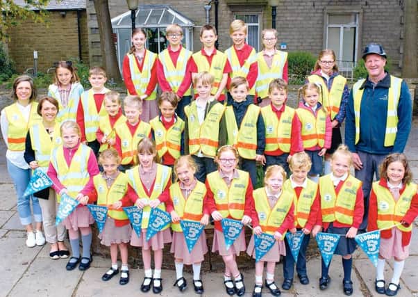 Vested interest: Darren Smith Homes supported The Hoppa by donating hi-vis vests for the children.